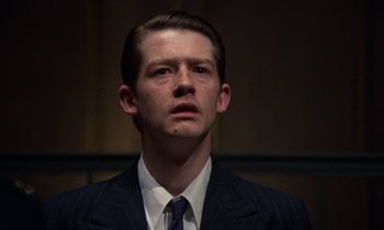 Movie still from “10 Rillington Place” (1971), directed by Richard Fleischer – A man wearing a suit and tie looking up; Close Up shot, Low angle
