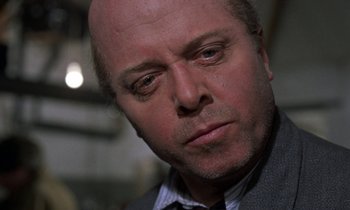 Movie still from “10 Rillington Place” (1971), directed by Richard Fleischer – A man with a bald head is looking at the camera; Close Up shot, Low angle