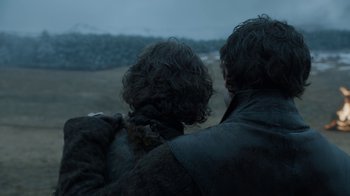 Movie still from “Game of Thrones” (2011), created by D.B. Weiss – Two people sitting in a field looking out at the sky; Close Up shot, Low angle