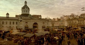 Movie still from “Crimson Peak” (2015), directed by Guillermo del Toro – A crowd of people standing on top of a city street; Extreme Wide shot, High angle