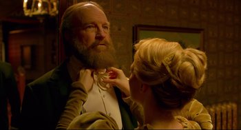 Movie still from “Crimson Peak” (2015), directed by Guillermo del Toro – A woman putting a tie on a man's neck; Close Up shot, Low angle