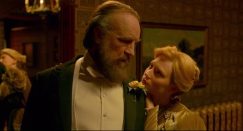 Movie still from “Crimson Peak” (2015), directed by Guillermo del Toro – An older man and a younger woman standing next to each other; Close Up shot, Low angle