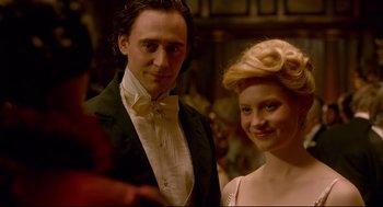Movie still from “Crimson Peak” (2015), directed by Guillermo del Toro – A man and a woman standing next to each other; Medium shot, Over the shoulder angle