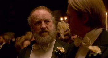 Movie still from “Crimson Peak” (2015), directed by Guillermo del Toro – A man with a beard wearing a tuxedo; Close Up shot, Over the shoulder angle