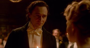 Movie still from “Crimson Peak” (2015), directed by Guillermo del Toro – A person wearing a suit and bow tie; Close Up shot, Over the shoulder angle