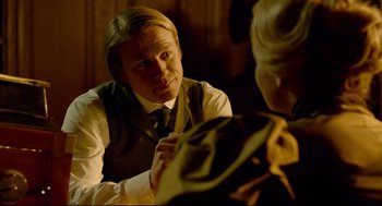 Movie still from “Crimson Peak” (2015), directed by Guillermo del Toro – A man sitting at a table with another man; Close Up shot, Over the shoulder angle