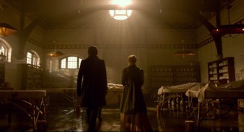 Movie still from “Crimson Peak” (2015), directed by Guillermo del Toro – A man and a woman walking through a room; Wide shot, Low angle
