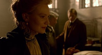 Movie still from “Crimson Peak” (2015), directed by Guillermo del Toro – A woman in a victorian dress looking at something in the distance; Close Up shot, Over the shoulder angle