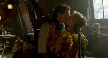 Movie still from “Crimson Peak” (2015), directed by Guillermo del Toro – A man and a woman kissing each other in front of a mirror; Medium shot, Low angle