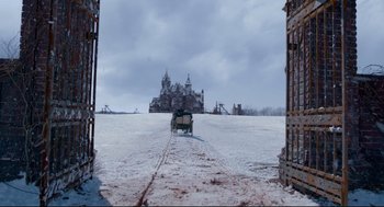 Movie still from “Crimson Peak” (2015), directed by Guillermo del Toro – A horse drawn carriage traveling through a snow covered field; Extreme Wide shot, Low angle