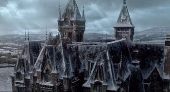 Movie still from “Crimson Peak” (2015), directed by Guillermo del Toro – A view of a castle with a clock tower; Extreme Wide shot, Low angle