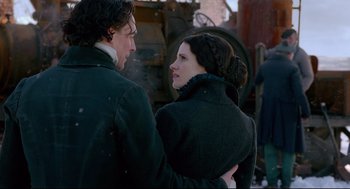 Movie still from “Crimson Peak” (2015), directed by Guillermo del Toro – A man and a woman standing next to each other; Medium shot, Over the shoulder angle