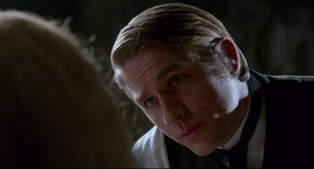 Movie still from “Crimson Peak” (2015), directed by Guillermo del Toro – A person wearing a suit and tie; Close Up shot, Over the shoulder angle