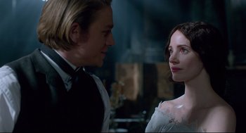 Movie still from “Crimson Peak” (2015), directed by Guillermo del Toro – A man and a woman standing next to each other in a room; Close Up shot, Over the shoulder angle