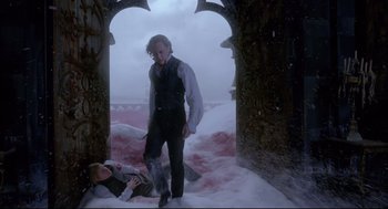 Movie still from “Crimson Peak” (2015), directed by Guillermo del Toro – A man standing next to a woman in a snowy field; Wide shot, High angle
