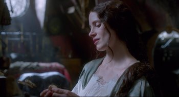 Movie still from “Crimson Peak” (2015), directed by Guillermo del Toro – A beautiful young lady sitting down with her eyes closed; Close Up shot, Over the shoulder angle