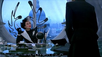 Movie still from “101 Dalmatians” (1996), directed by Stephen Herek – A woman sitting at a desk in front of a mirror; Medium shot, Over the shoulder angle