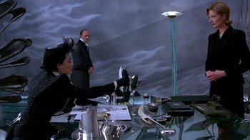 Movie still from “101 Dalmatians” (1996), directed by Stephen Herek – A man and a woman are sitting at a dinner table; Wide shot, High angle