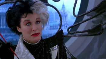 Movie still from “101 Dalmatians” (1996), directed by Stephen Herek – An older woman in a black and white outfit; Close Up shot, Low angle