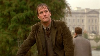 Movie still from “101 Dalmatians” (1996), directed by Stephen Herek – A man in a brown jacket and a brown tie; Close Up shot, Low angle