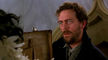 Movie still from “101 Dalmatians” (1996), directed by Stephen Herek – A person with a suitcase; Close Up shot, Over the shoulder angle