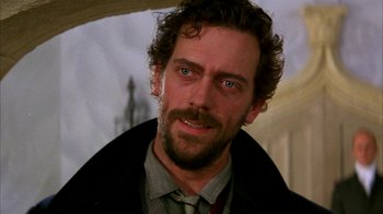 Movie still from “101 Dalmatians” (1996), directed by Stephen Herek – A person wearing a suit and tie; Close Up shot, Over the shoulder angle