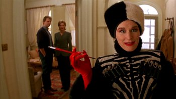 Movie still from “101 Dalmatians” (1996), directed by Stephen Herek – A woman in a zebra costume holding a red pencil; Close Up shot, Over the shoulder angle