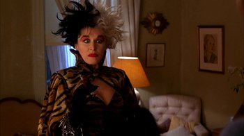 Movie still from “101 Dalmatians” (1996), directed by Stephen Herek – A woman in a tiger print outfit with white hair and red lipstick; Medium shot, Low angle