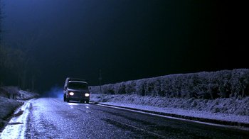 Movie still from “101 Dalmatians” (1996), directed by Stephen Herek – A car driving down a road at night; Extreme Wide shot, Low angle