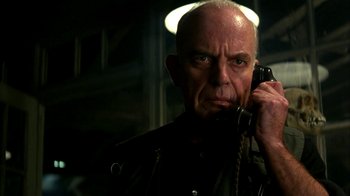 Movie still from “101 Dalmatians” (1996), directed by Stephen Herek – An older man holding a phone to his ear; Close Up shot, Low angle