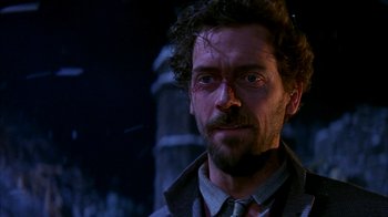 Movie still from “101 Dalmatians” (1996), directed by Stephen Herek – A person wearing a suit and tie; Close Up shot, Low angle