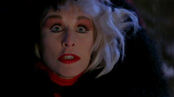 Movie still from “101 Dalmatians” (1996), directed by Stephen Herek – A person wearing a wig and makeup; Close Up shot, High angle