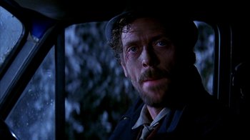 Movie still from “101 Dalmatians” (1996), directed by Stephen Herek – A person wearing a hat; Close Up shot, Over the shoulder angle