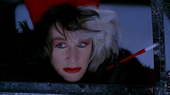 Movie still from “101 Dalmatians” (1996), directed by Stephen Herek – A person wearing a wig; Close Up shot, Overhead angle