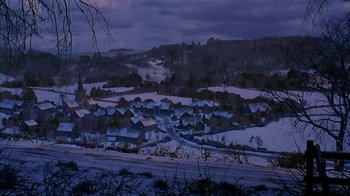 Movie still from “101 Dalmatians” (1996), directed by Stephen Herek – A view of a town in the snow at night; Extreme Wide shot, High angle