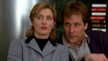 Movie still from “101 Dalmatians” (1996), directed by Stephen Herek – A man and a woman standing next to each other; Close Up shot, Low angle