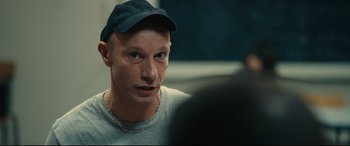 Movie still from “120 BPM” (2017), directed by Robin Campillo – A person wearing a hat; Close Up shot, Over the shoulder angle