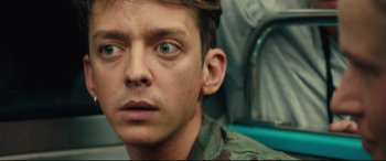 Movie still from “120 BPM” (2017), directed by Robin Campillo – A person wearing a military uniform; Close Up shot, Over the shoulder angle