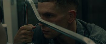 Movie still from “120 BPM” (2017), directed by Robin Campillo – A person holding a metal object; Close Up shot, Low angle