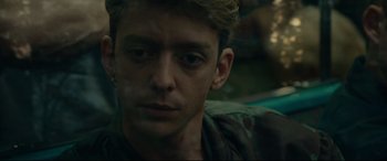 Movie still from “120 BPM” (2017), directed by Robin Campillo – A person wearing a camouflage shirt; Close Up shot, Over the shoulder angle