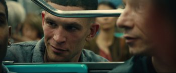 Movie still from “120 BPM” (2017), directed by Robin Campillo – A person on a train; Close Up shot, Over the shoulder angle