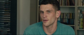 Movie still from “120 BPM” (2017), directed by Robin Campillo – A person wearing a green shirt; Close Up shot, Over the shoulder angle