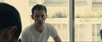 Movie still from “120 BPM” (2017), directed by Robin Campillo – A man sitting in front of a window; Close Up shot, Over the shoulder angle