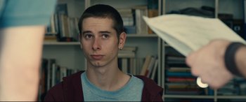 Movie still from “120 BPM” (2017), directed by Robin Campillo – A young man is looking into the distance; Close Up shot, Over the shoulder angle