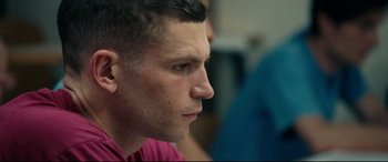 Movie still from “120 BPM” (2017), directed by Robin Campillo – A person looking to his left; Close Up shot, Over the shoulder angle
