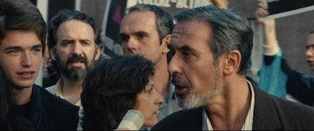 Movie still from “120 BPM” (2017), directed by Robin Campillo – A group of people standing next to each other on the street; Close Up shot, Over the shoulder angle