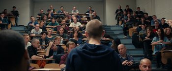 Movie still from “120 BPM” (2017), directed by Robin Campillo – A group of people sitting in front of a man in a lecture hall; Wide shot, Over the shoulder angle