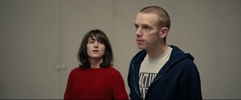 Movie still from “120 BPM” (2017), directed by Robin Campillo – A man and a woman standing next to each other; Medium shot, Over the shoulder angle