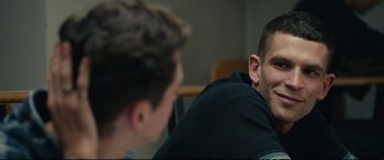 Movie still from “120 BPM” (2017), directed by Robin Campillo – Two young men are sitting in a room; Close Up shot, Over the shoulder angle