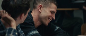 Movie still from “120 BPM” (2017), directed by Robin Campillo – A person smiling at something; Close Up shot, Over the shoulder angle